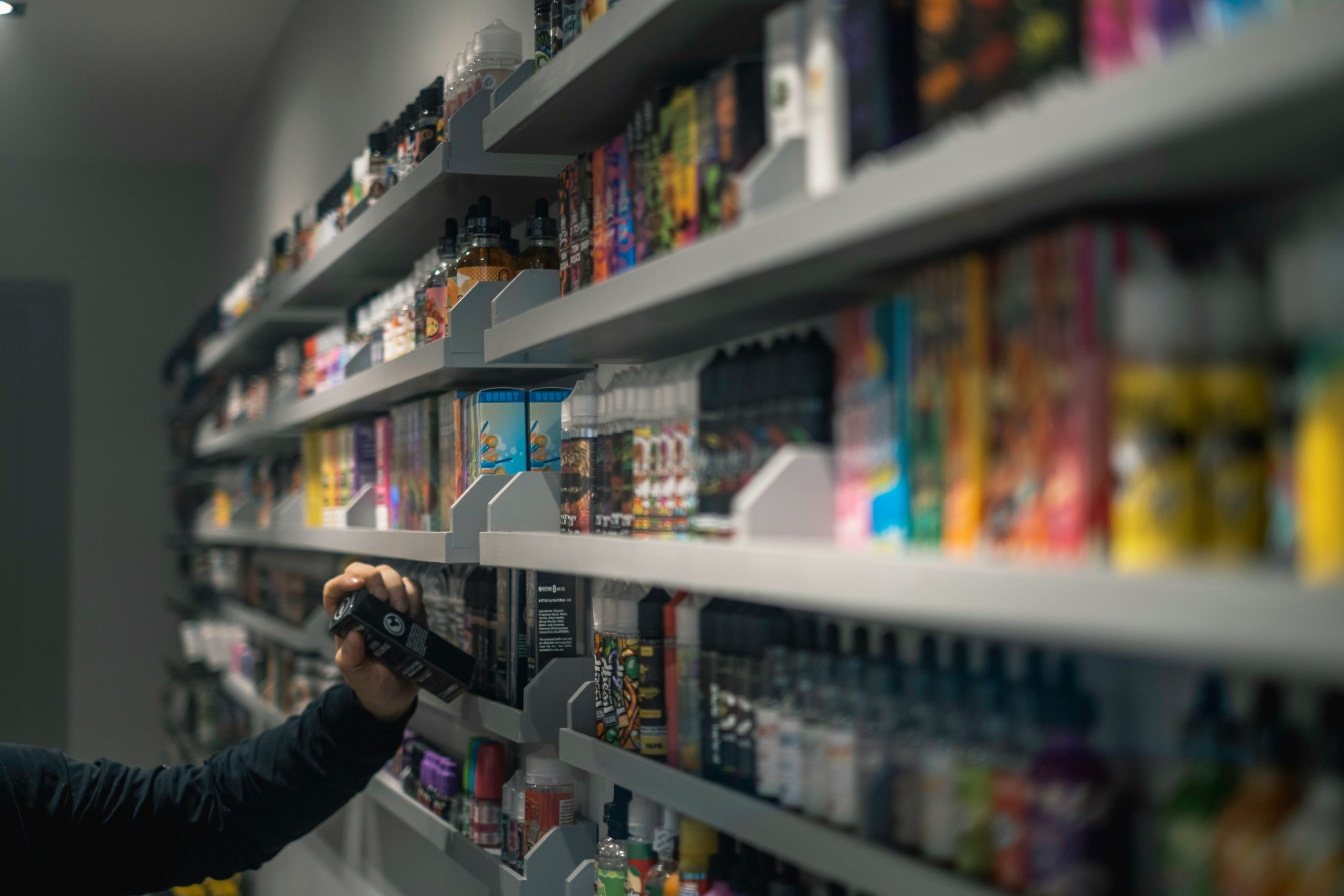 An image shows the inside of a shop selling vape products.